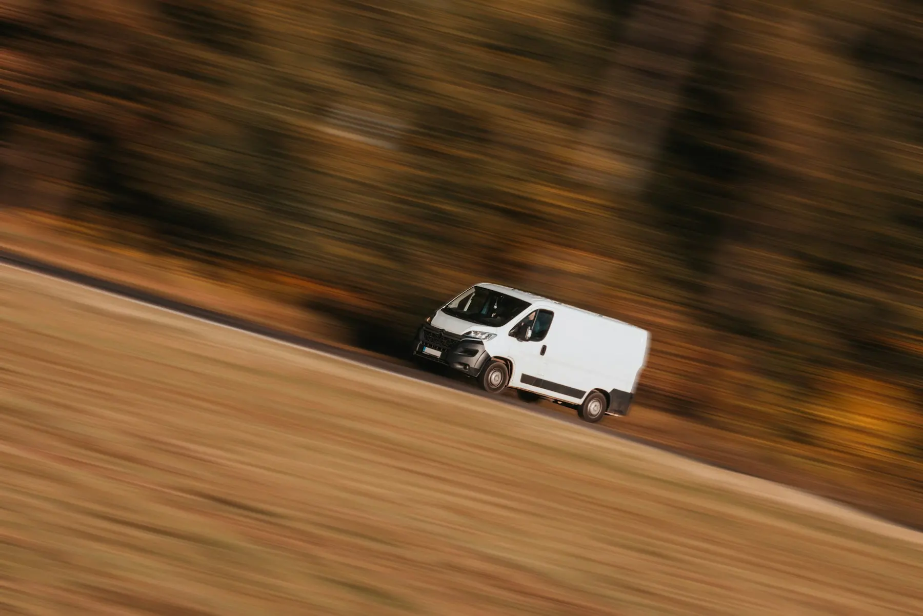 A white delivery van on the move.