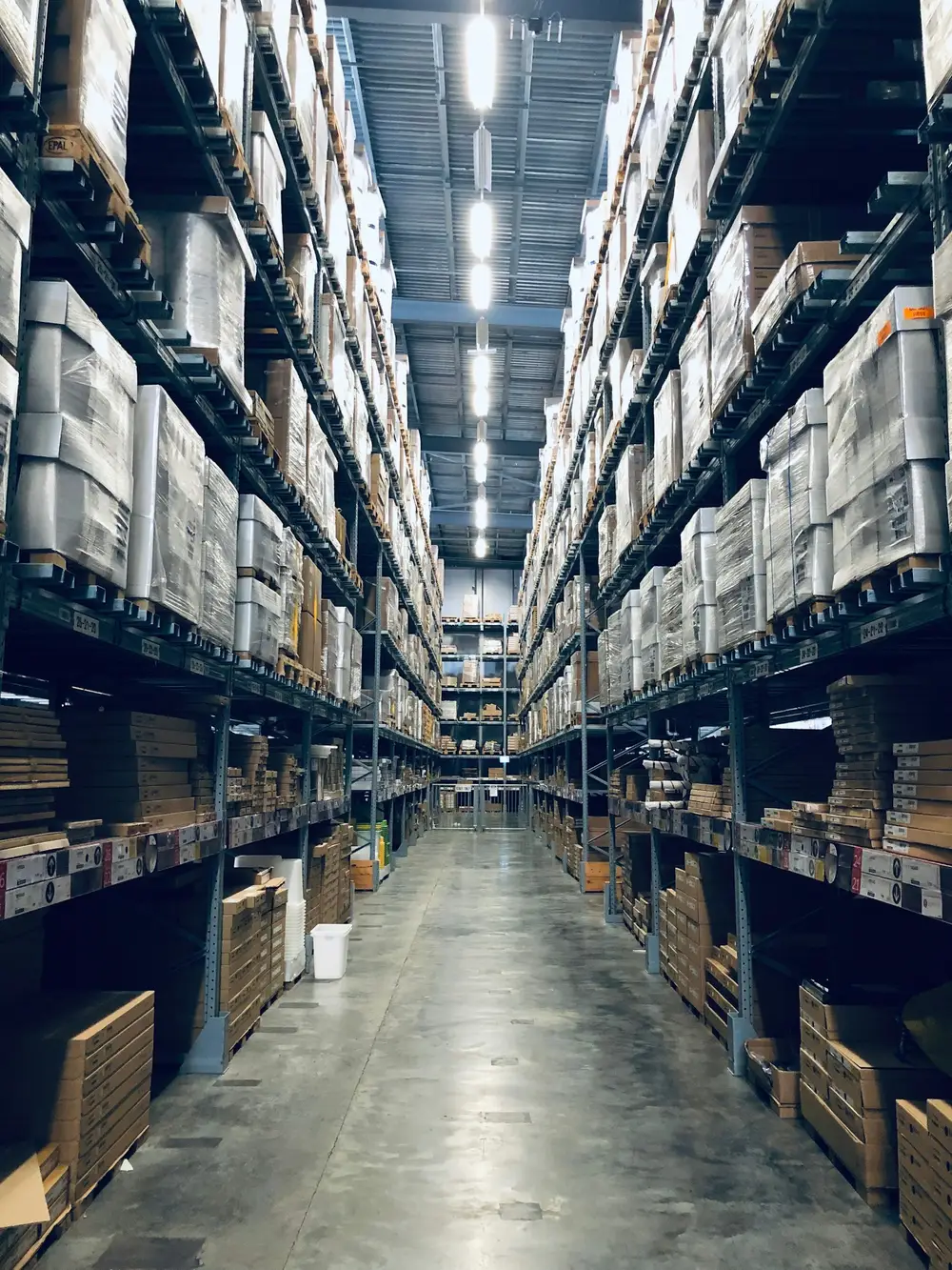 A long aisle of warehouse shelving.